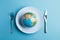 Globe on a plate for food on a blue background. Power, economy, politics, globalism, hunger, poverty and world food concept