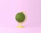 Globe sphere orb lemon, lime concepts on pastel pink background.