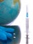 Globe and syringe, pills, medical glove on a white background. Medicine, healthcare and medicine, vaccination