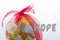 Globe tied with ribbon beside hope wording