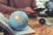 Globe, whole world  on passport and focus United states country and man use phone . The route map on the table. Travel , Adventure