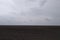 Gloomy agricultural field after harvesting corn. Overcast landscape