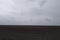 Gloomy agricultural field after harvesting corn. Overcast landscape
