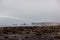 Gloomy beach coast of the village of Vic. Iceland. Deserted cloudy traditional view. Rocks in the water.