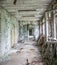 Gloomy corridor with broken window frames and debris