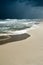 Gloomy dark cloudy sky, turbulent sea waves. Empty overcast beach just before the wild rainfall