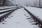 Gloomy railroad in the winter time of the year with snow