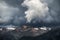 Gloomy rain clouds over the mountains. Beautiful nature. Green dense forests. Bird's-eye view