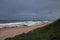 GLOOMY SKY OVER BREAKING WAVES