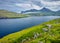 Gloomy summer view of Eidi village. Fresh morning scene of Eysturoy island. Green landscape of Faroe Islands, Denmark, Europe. Bea