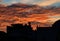 Glorious altocumulus cloud sunset behind silhouette of village skyline.