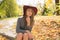 Glorious blonde model in red hat posing at the forest, wearing t