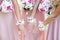 Glorious bridesmaids in pink dresses holding beautiful flowers