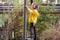 Glorious girl standing on construction at playground, turning head over shoulder, looking at camera with happy smile.