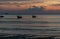 Glorious tropical sunset on the beach of Ao Nang, Province of Krabi, Thailand, with two long tail boats