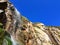 Glorious waterfall at Porthcurno beach, Cornwall looking up into deep blue sky