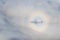 Glory light phenomenon around the shadow of a plane.Glory of the Pilot is Rainbow Encircles an Airplane Shadow on Clouds