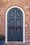 Glossy blue door to classic brownstone home