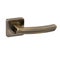 Glossy door handle in bronze with a greenish tint on a square base in a classic style