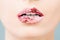 Glossy lips, beautiful makeup with red and pink lipstick. Close up macro beautiful mouth