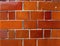 Glossy orange brick wall