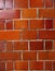 Glossy orange brick wall