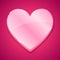 Glossy plastic heart on pink background