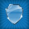 Glossy security shield on blue background