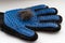 Glove for pet grooming with combed wool on a light background. Blue glove for collecting hair from a pet. Cat hair in a