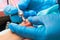 A gloved craftsman removes the nail polish from the toe plate with a milling cutter.