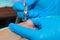 A gloved craftsman removes the nail polish from the toe plate with a milling cutter.