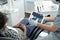 Gloved dentist enlarging x-ray of human teeth on tablet screen
