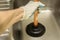 a gloved hand pumps a pipe in the sink with a vantus