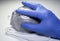 A gloved hand takes a mask from a set of FFP2 medical masks. Face mask protection against pollution, virus, flu and coronavirus