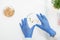 Gloved hands of researcher touching petri dish containing lab-grown soy sprouts