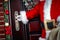 Gloved hands of Santa Claus open the door