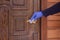A gloved man rubs a doorknob. Handle disinfectant. The concept of cleaning the house during the coronavirus. Sanitary treatment at