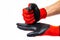 Gloves for workers, construction red with black rubber coating. Black-red gloves. A gloved hand knocks, punches a gloved  palm