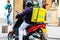 A Glovo food delivery courier on a scooter. Restaurants are closed and only deliveries are allowed during the state of emergency