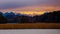 Glowing alpine mountains in Upper Bavaria in the evening with lake and marshland in foreground