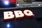 Glowing bbq signboard at night