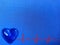 Glowing blue heart with red cardiogram graph on blue texture