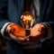 Glowing bulb in CEOs hand signifies business acumen and ingenuity