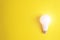 Glowing bulb on yellow background, uniqueness concept. Idea, innovation, creativity concept, design template, copy space