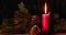 Glowing candle with Christmas decoration