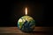 Glowing Candle in the Dark: Earth Hour Symbol.