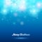 Glowing christmas background. Snowflakes on blue.