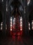 glowing Christmas tree decorated with red and black ornaments in a and gothic cathedral. Gothic art. AI generation