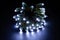 Glowing cold white led pixels christmas holiday lights on black background