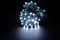 Glowing cold white led pixels christmas holiday lights on black background